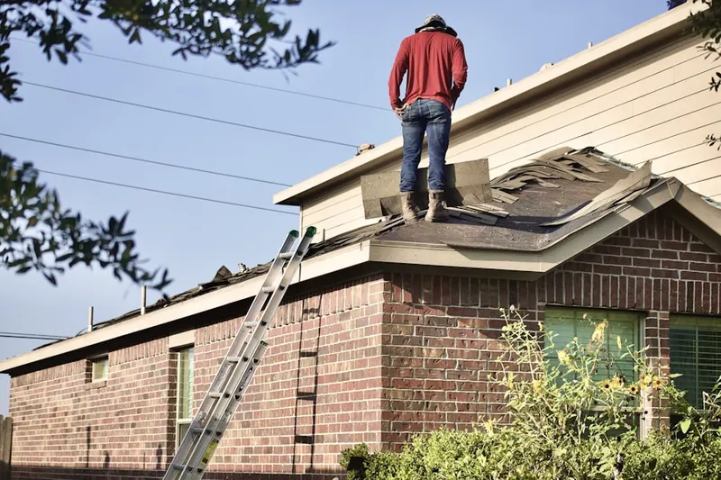 Professional roofer working on a residential roof in Woods of Brushy Creek